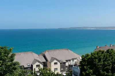 a group of houses next to the ocean at Fairsky - Sea Views and Allocated Parking in Carbis Bay