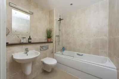 a bathroom with a sink and a toilet and a bath tub at Ocean lookout & explore the coast in Newquay