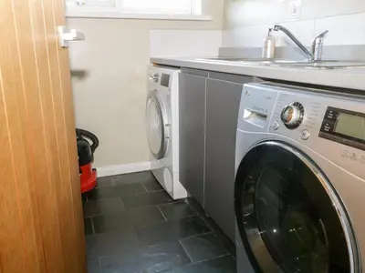 a washing machine in a kitchen with a sink at Ocean View in Torpoint