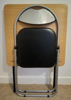 a chair with a surfboard on top of it at West Looe Downs in Looe