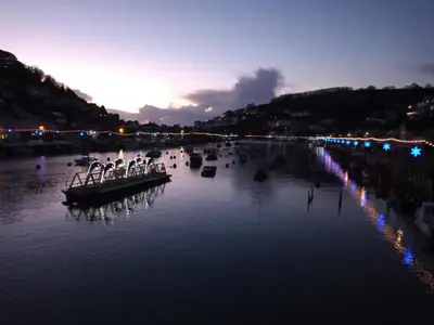 a group of boats on a river at night at West Looe Downs in Looe