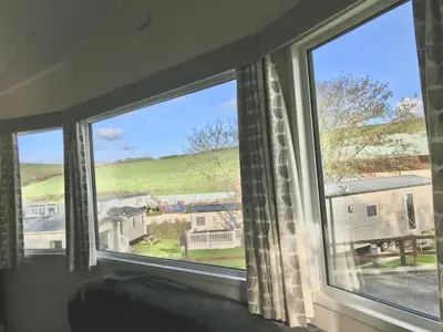 a window with a view of a house at NB12 Entire Caravan - Newquay in Porth