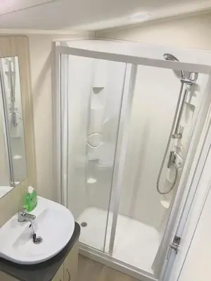 a bathroom with a shower and a sink at NB12 Entire Caravan - Newquay in Porth