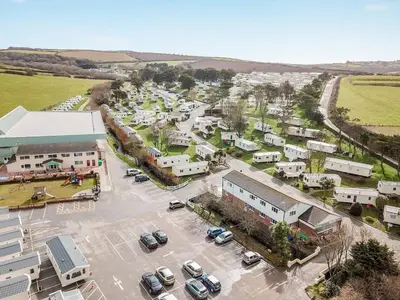 an aerial view of a town with cars parked in a parking lot at NB12 Entire Caravan - Newquay in Porth
