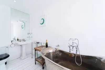 a bathroom with a tub and a sink at St Ives House in St Ives