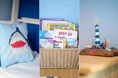 a bedroom with a shark pillow and books and a lighthouse at Victoria House in St Ives