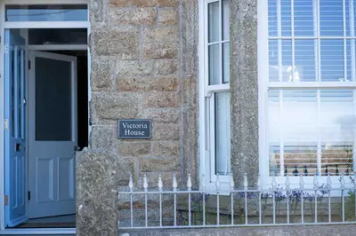 a front door of a house with a sign on it at Victoria House in St Ives