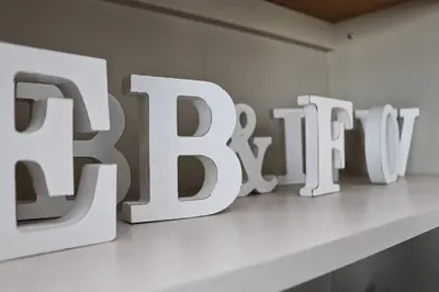 a row of white letters on a shelf at Holiday home with Estuary Views, parking & balcony in Padstow
