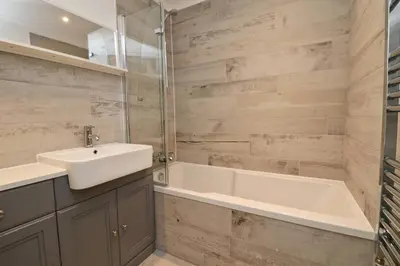 a bathroom with a sink and a bath tub at Holiday home with Estuary Views, parking & balcony in Padstow
