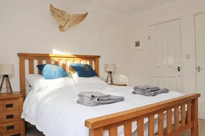 a bedroom with a bed with towels on it at Holiday home with Estuary Views, parking & balcony in Padstow