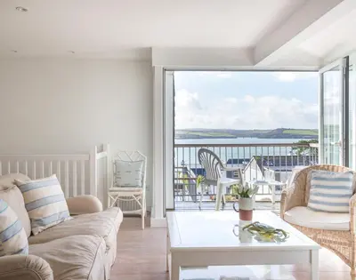 a living room with a couch and a table at Slipway 19 in Padstow