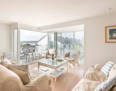 a living room with a couch and a table at Slipway 19 in Padstow