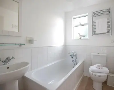 a bathroom with a tub and a toilet and a sink at Slipway 19 in Padstow
