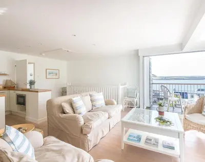a living room with a couch and a table at Slipway 19 in Padstow