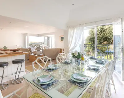 a dining room and kitchen with a table and chairs at Slipway 19 in Padstow