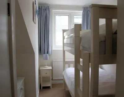 a bedroom with a bunk bed and a window at Slipway 10 in Padstow