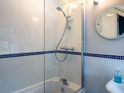 a bathroom with a shower and a tub and a sink at Lowenna Manor 4 in Padstow