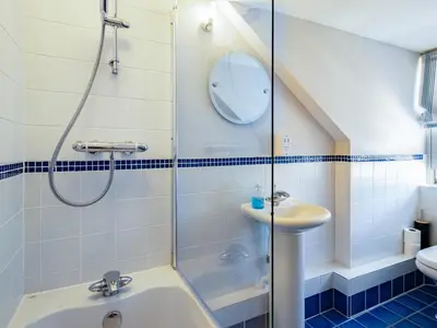 a bathroom with a shower and a sink at Lowenna Manor 4 in Padstow