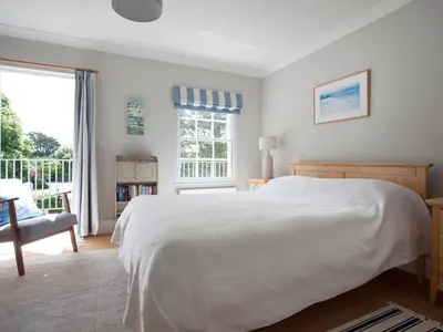 a bedroom with a white bed and a window at Lowenna Manor 4 in Padstow