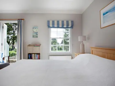 a bedroom with a white bed and a window at Lowenna Manor 4 in Padstow