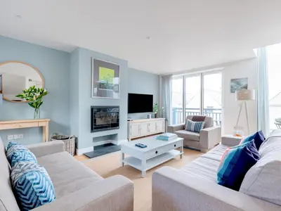 a living room with a couch and a tv at Epphaven in Polzeath