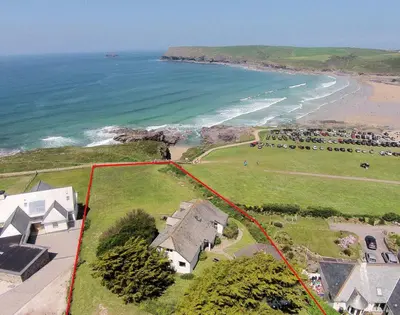 an aerial view of a house next to the ocean at Gullsway Kittiwake in Polzeath