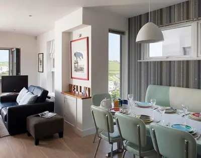a living room with a table and chairs and a couch at Kellan in Polzeath