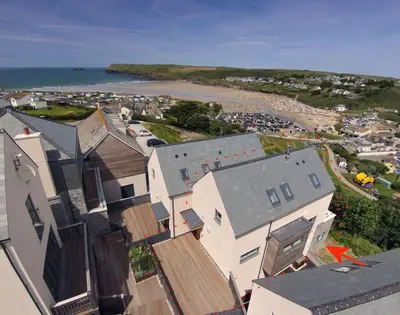 an aerial view of a town with houses and a beach at Kellan in Polzeath