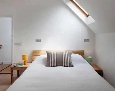 a bedroom with a white bed with a pillow on it at Kellan in Polzeath