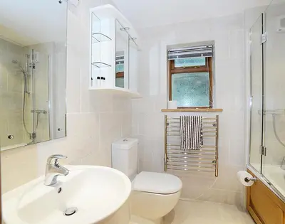 a white bathroom with a sink and a toilet at Sandy Hills 8 in Padstow
