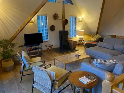 a living room with couches and chairs and a tv at Sandy Hills 8 in Padstow