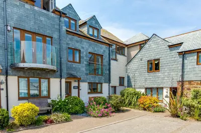 a large house with a blue brick facade at Rock Lobster in Port Isaac