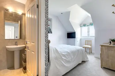 a bathroom with a bed and a sink in a room at Rock Lobster in Port Isaac