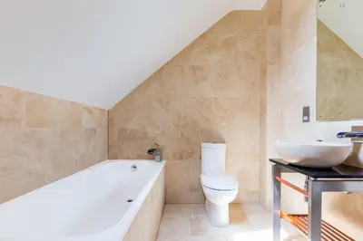 a bathroom with a tub and a toilet and a sink at Rock Lobster in Port Isaac