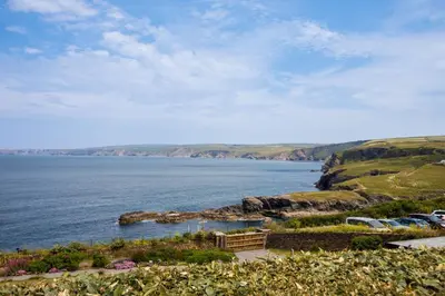 an aerial view of a body of water with rocks at Rock Lobster in Port Isaac