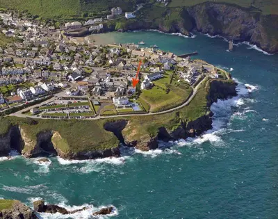 an aerial view of a village on the edge of the ocean at Signal Post in Port Isaac