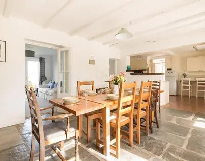 a dining room with a wooden table and chairs at Signal Post in Port Isaac