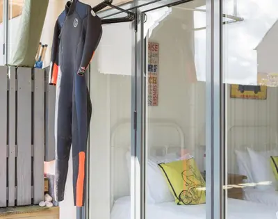 a mannequin standing on a bed in a display window at Rainer Rocks in Polzeath