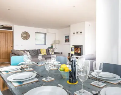 a dining room table with wine glasses on it at Rainer Rocks in Polzeath