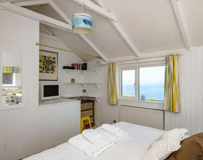 a bedroom with a bed with two white pillows at The Folly in Port Isaac