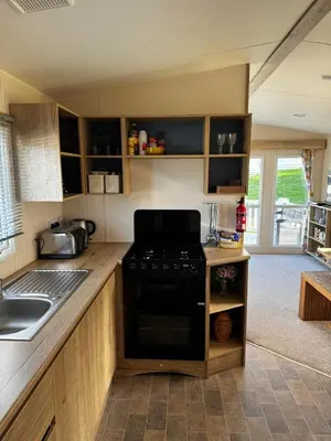 a kitchen with a stove and a sink in it at PV70 newquay bay resort in Porth