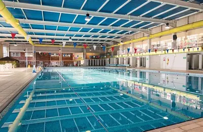 a large swimming pool filled with blue water at PV70 newquay bay resort in Porth