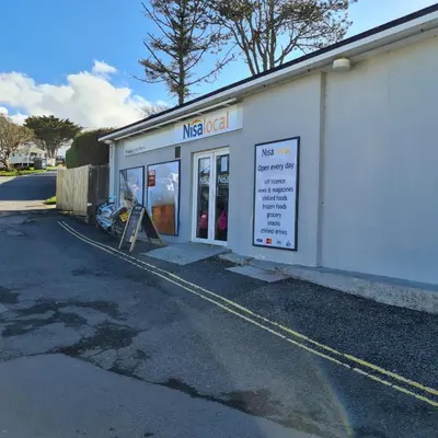 a nigerian store with a sign in front of it at PV70 newquay bay resort in Porth