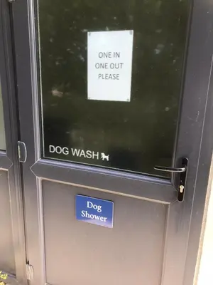 a dog wash machine with two signs on it at 1.2 padstow in Padstow