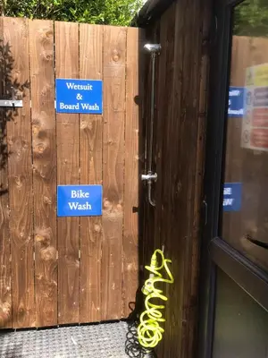 a wooden fence with signs on it and a pair of yellow rope at 1.2 padstow in Padstow