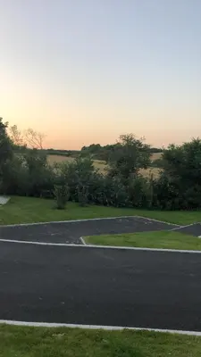 an empty parking lot next to a field at 1.2 padstow in Padstow
