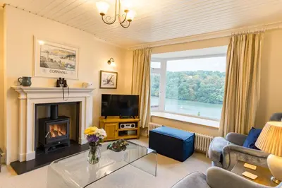 a living room with a fireplace and a television at Finest Retreats - Tideway in Saint Clement