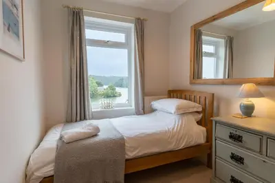 a small bedroom with a bed and a window at Finest Retreats - Tideway in Saint Clement