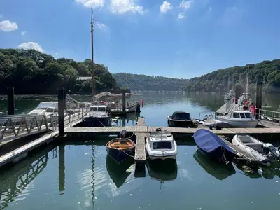 a group of boats docked at a dock in the water at Finest Retreats - Tideway in Saint Clement