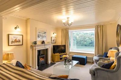 a living room with a fireplace and a tv at Finest Retreats - Tideway in Saint Clement